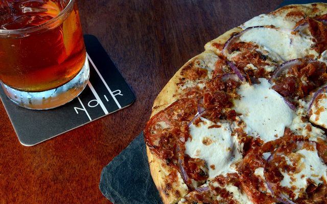 A cocktail and flat-bread pizza