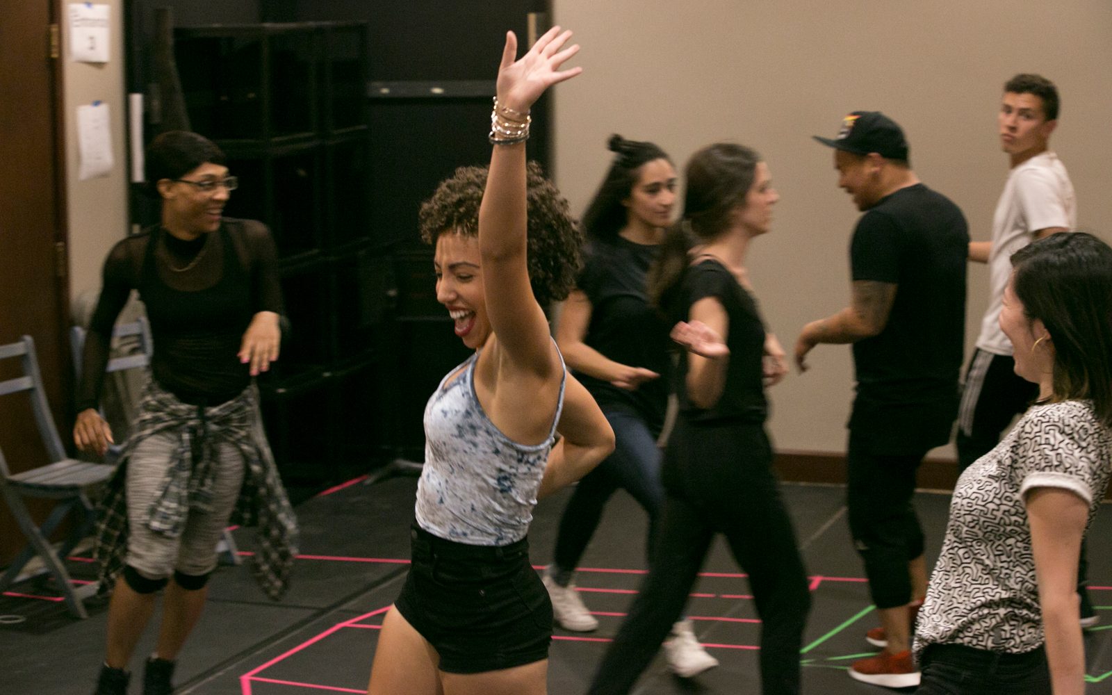 Cast members warming up in rehearsal.