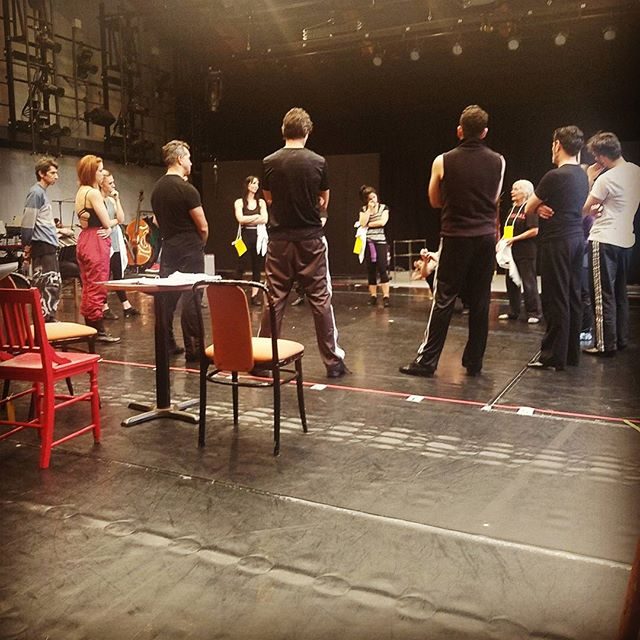 Actors in rehearsal standing in a circle
