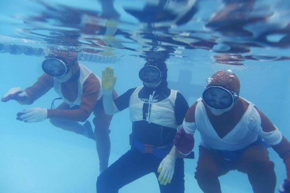 Wai Ching Ho, Emily Kuroda, and Jo Yang rehearse underwater for Endlings.