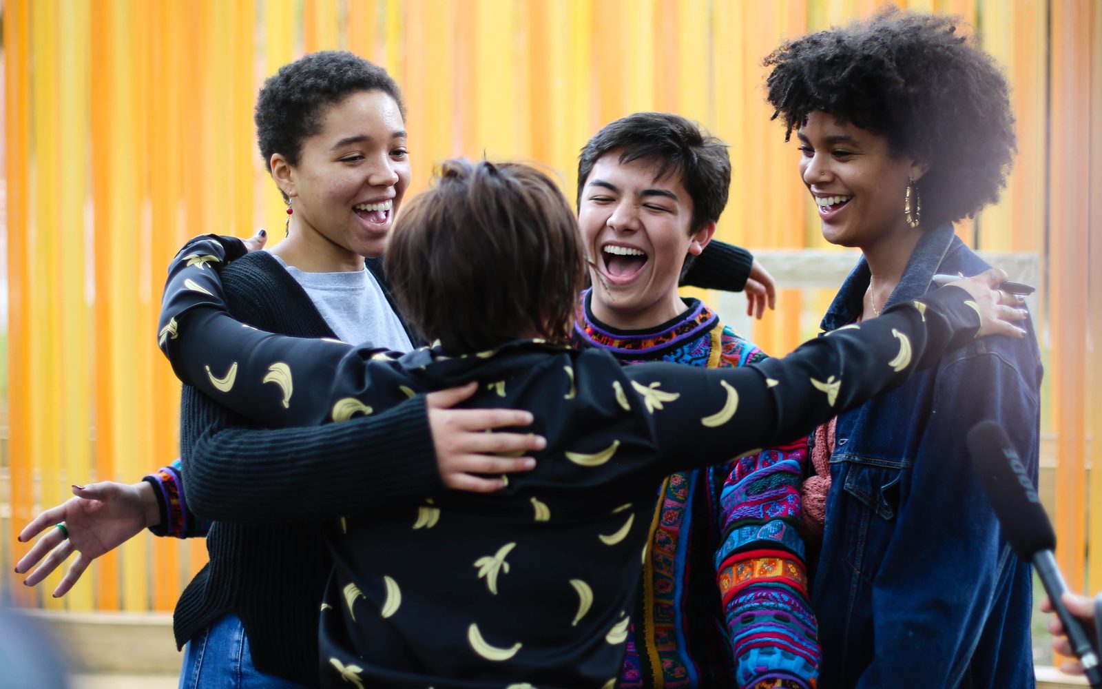 Diana Oh embraces Arianne Banda, Michael Rosegrant, and Mya Ison.