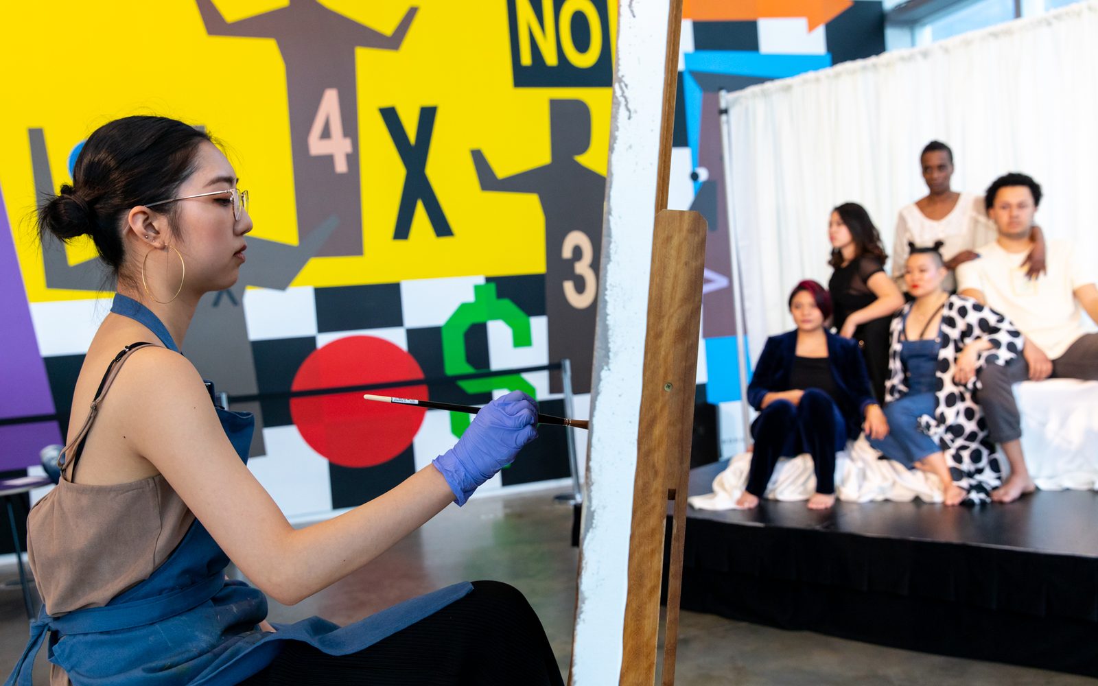 Leena Cho painting the group portrait of Mei Ann Teo, Sarah Shin, Diana Oh, Cassandre “Jolie LaVie” Charles, and Ian Askew at The Artist in Their Element.