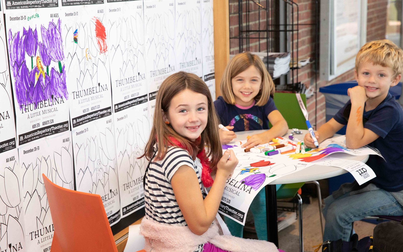 Young attendees color posters for Thumbelina at the A.R.T. Open House.