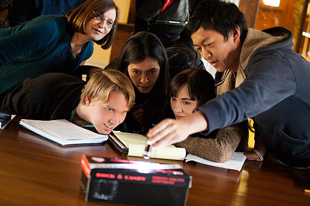 Teachers and students look at a magic trick