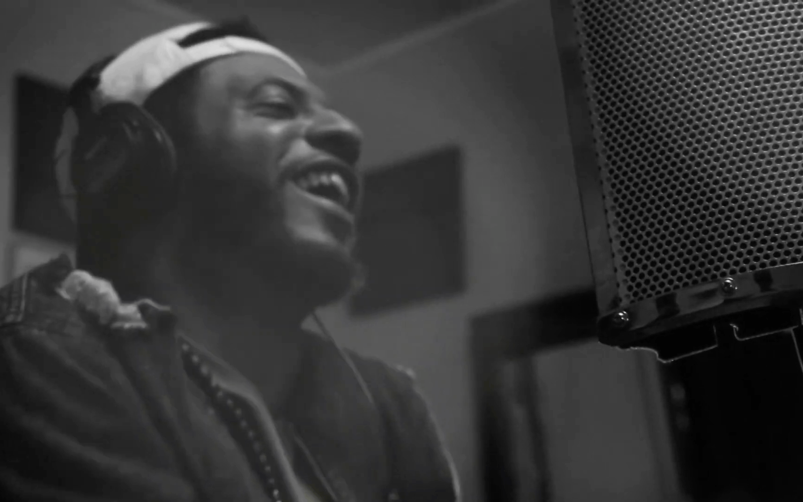 Young Black man singing into a microphone