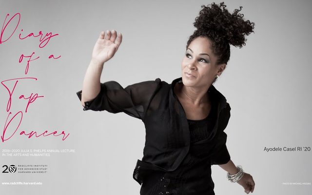 Ayodele Casel in front of a white backdrop.