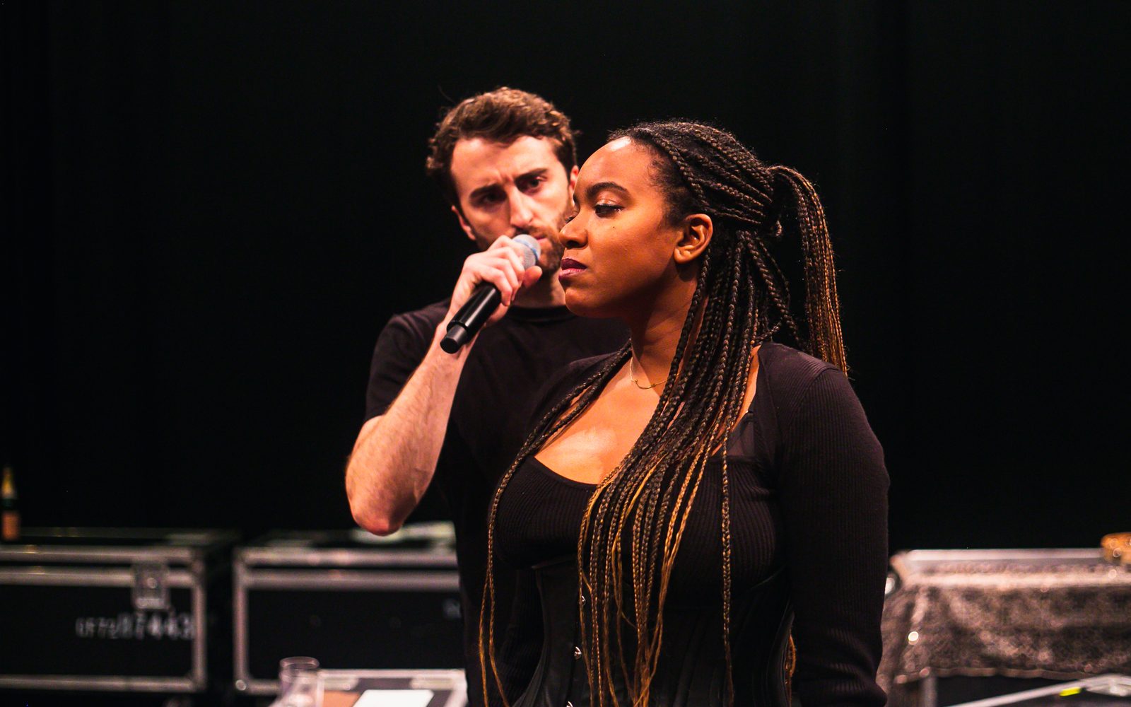 Charlie Thurston singing behind Whitney White.