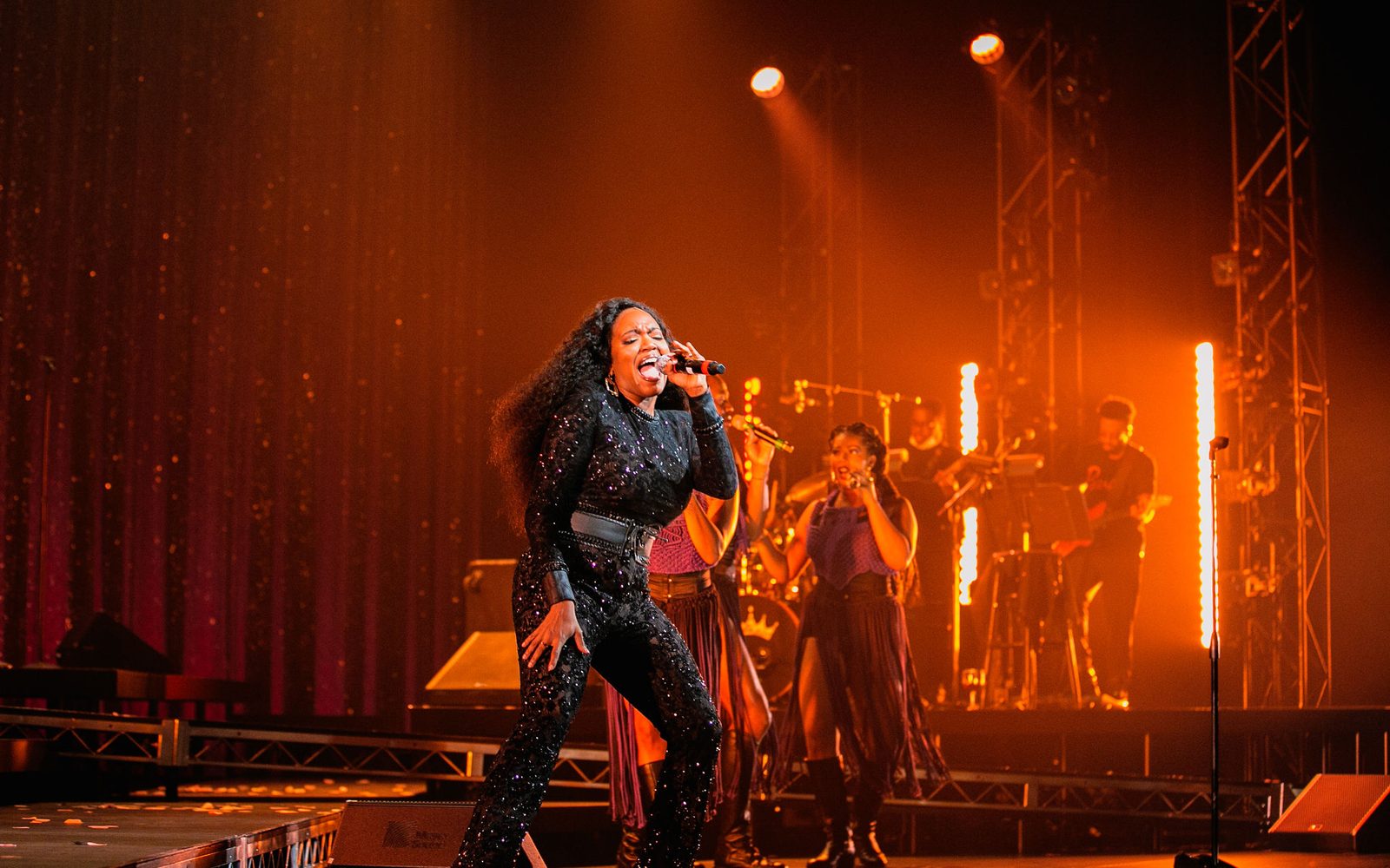 Whitney White dancing and singing, backed up by Kira Sarai Helper singing and the band.