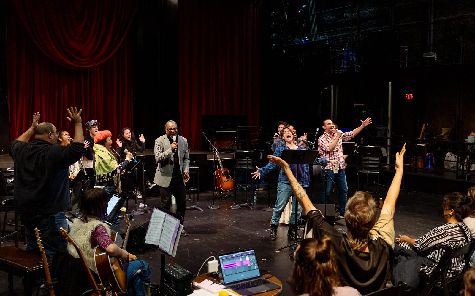 The company of WILD: A Musical Becoming singing while the creative team looks on.