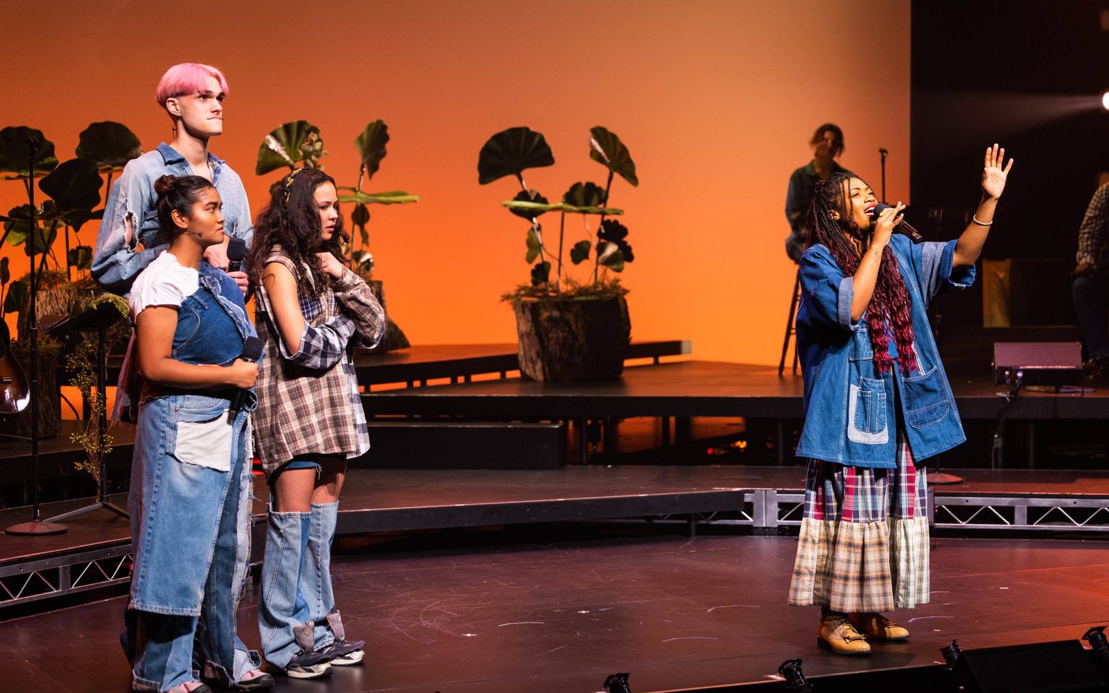 Paravi Das, Luke Ferrari, and YDE standing to the left as Brittany Campbell speaks in WILD: A Musical Becoming.