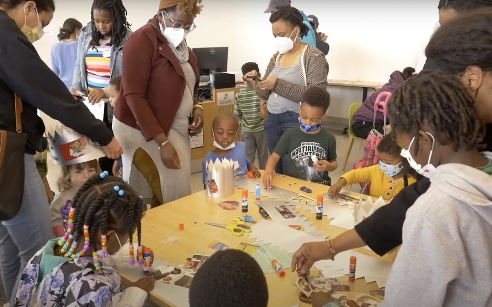 Children and their parents at a crown-making workshop.