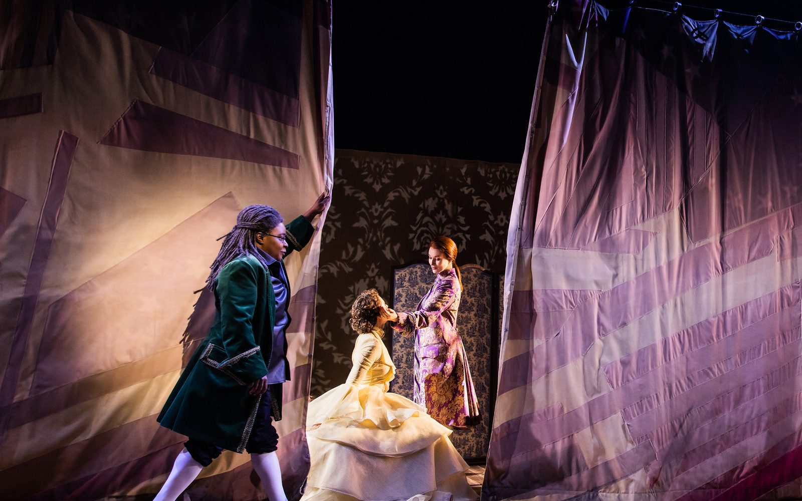 Patrena Murray closes a curtain in front of Elizabeth A. Davis staring at Eryn LeCroy.