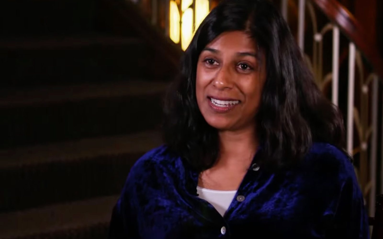 Lolita Chakrabarti in a blue satin blouse.