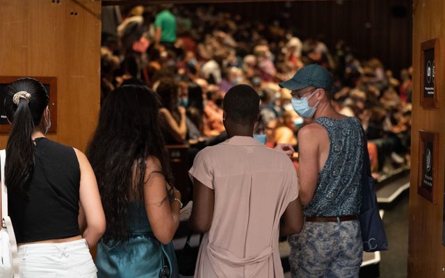Audience members entering the theater.