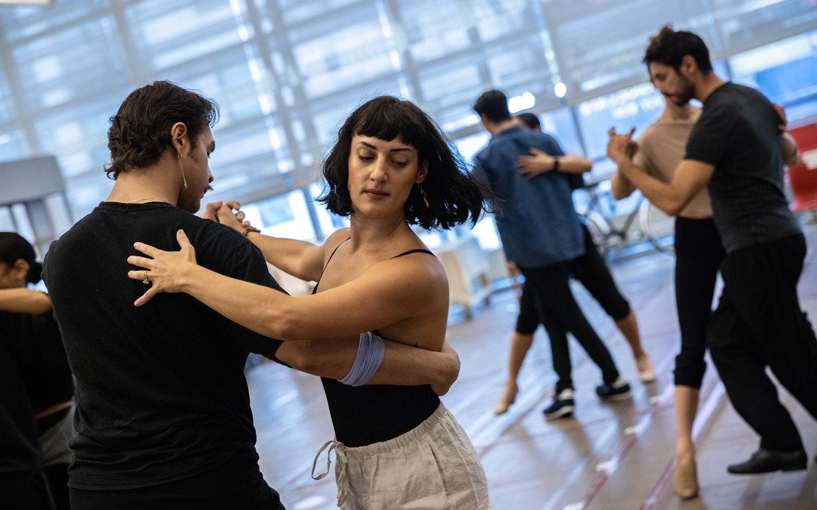 Caleb Marshall-Villarreal and Adrienne Balducci embraced in a turn as other members of the cast tango behind them.