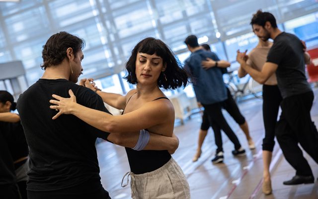 Caleb Marshall-Villarreal and Adrienne Balducci embraced in a turn as other members of the cast tango behind them.