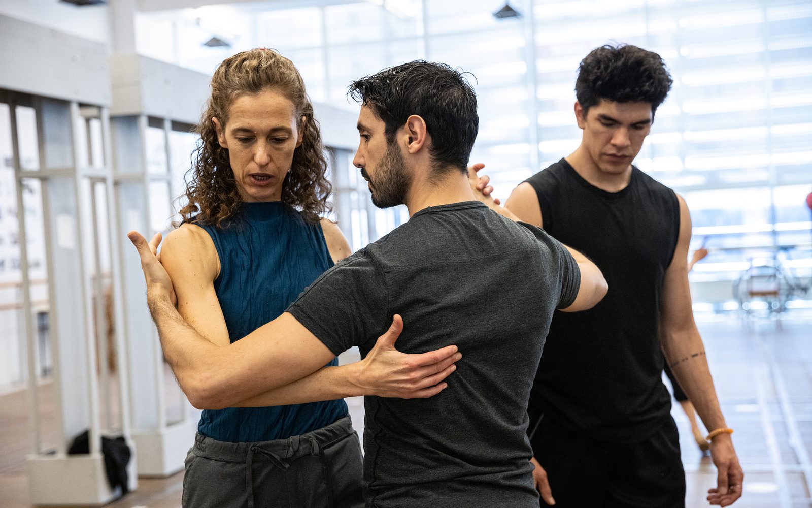 Co-Choreographer Valeria Solomonoff leads Martin Almiron in a tango step as Jonatan Lujan passes behind them.