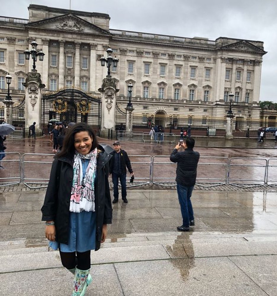 Shereen Pimentel standing in front of Buckingham Palace