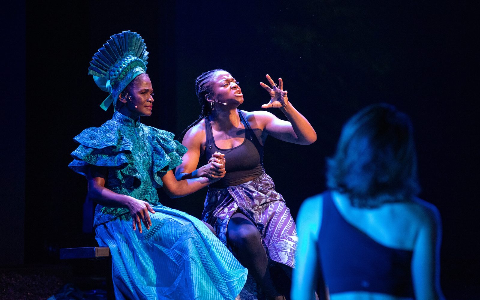 Patrice Johnson Chevannes clutches Jennifer Mogbock’s hand as she gesticulates.