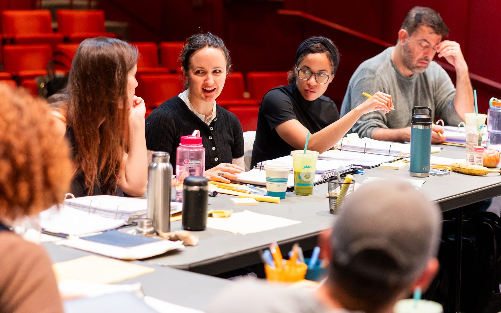 Shana Cooper, Kate Hamill, Steph Paul, and Jason O’Connell sit a table in front of their script binders.