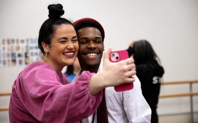 Lucy Godínez holds up her phone to take a selfie with Sage.