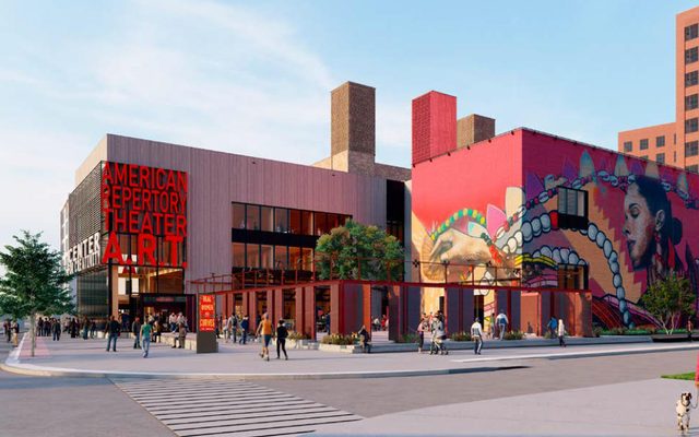 The exterior during the day, with the outdoor Yard centered and a large mural on wall to the right.