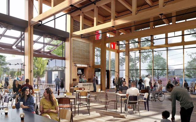 The lobby filled with people at cafe tables. The retractable wall is open, with additional seating in the courtyard.