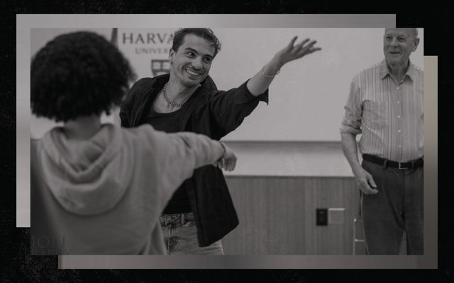 A young mean reaches towards the ceiling while smiling