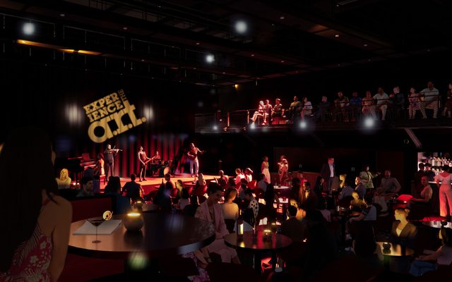 A band performs in the darkened East Stage surrounded by the audience in cabaret seating.