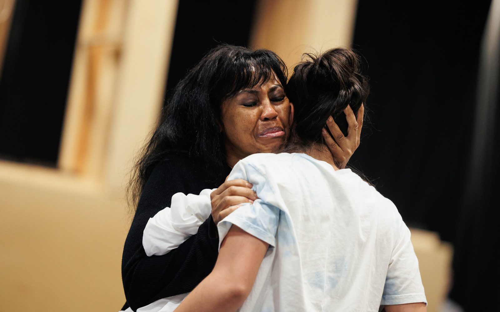 Sharon Catherine BRown cries while pulling Emilia Suárez in for a deep hug.