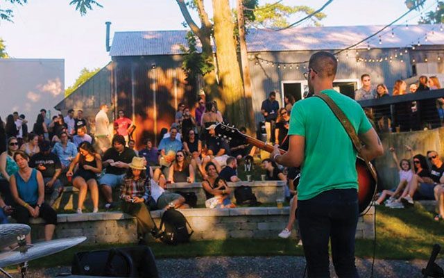 A guitarist playing for a crowf