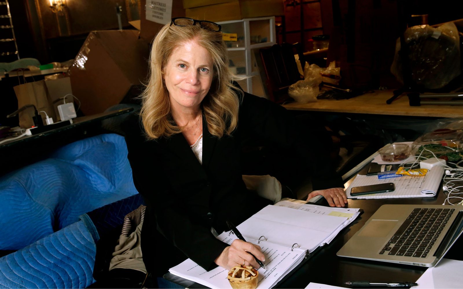 Jessie Nelson poses with a script while working in at a table.